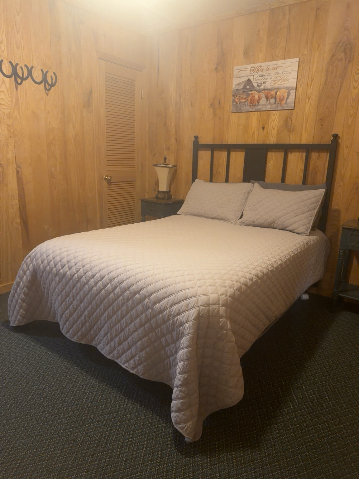 Queen room with wood paneling